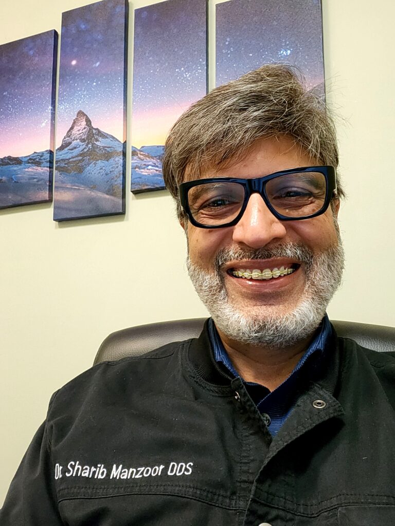 Dr. Sharib Manzoor photographed in a professional setting at MI Dental in Kitchener, Ontario