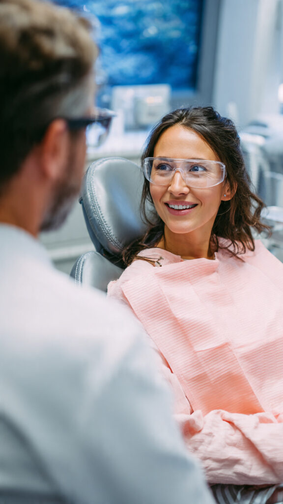 A smiling patient having a comfortable gum health consultation with a dentist at MI Dental in Kitchener.